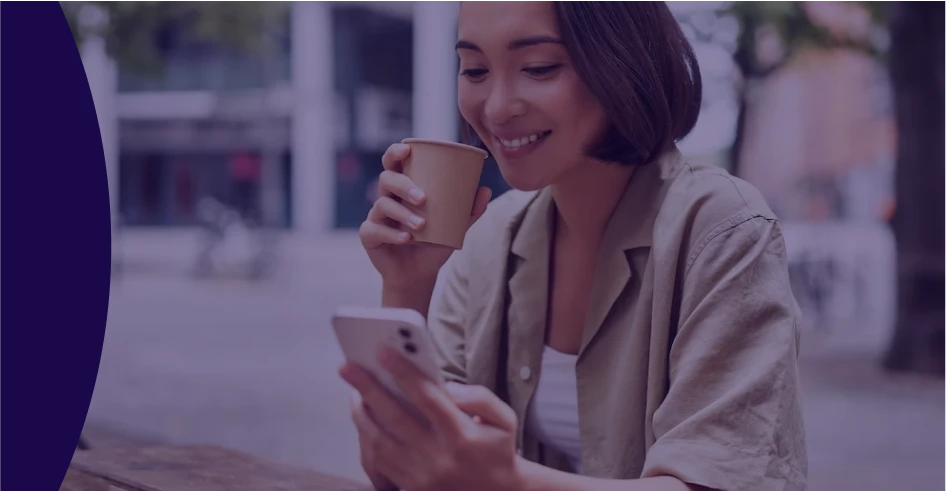woman having coffee and looking at a phone